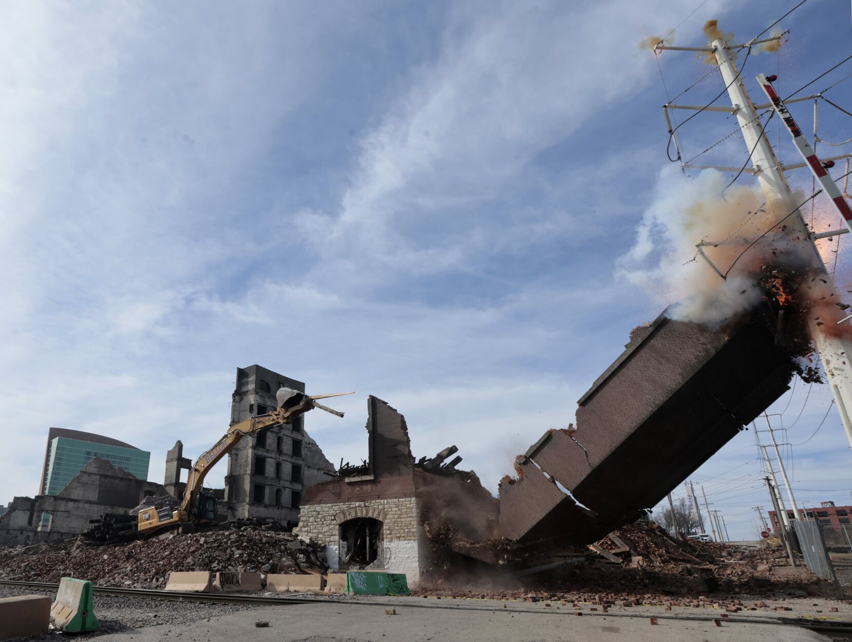 Demolition crew hits electric transmission line causing an explosion